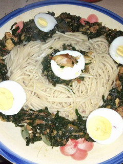 A picture of Spaghetti with vegetables and boiled egg.