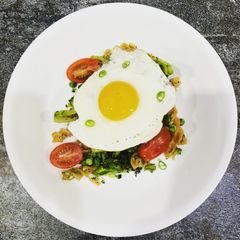 A picture of Avocado and basil red lentil pasta with a crispy fried egg.