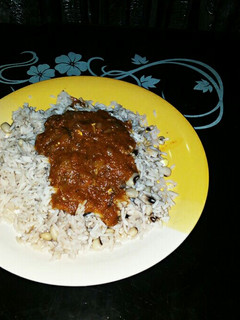 A picture of Rice and beans with stew.