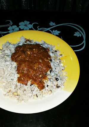 A picture of Rice and beans with stew.