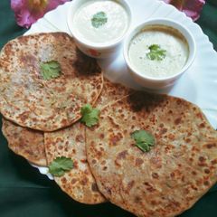 A picture of Lauki paratha with mint raita.