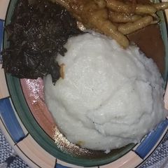 A picture of Chicken's feet and spinach also pap.