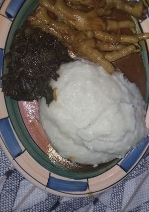 A picture of Chicken's feet and spinach also pap.