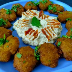 A picture of Pitta bread with Falafel and Hummus.