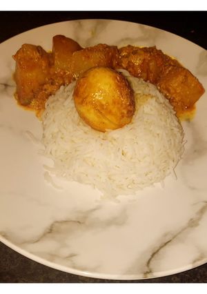 A picture of Egg curry with bell peppers.