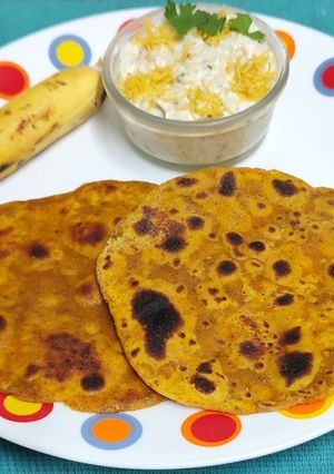 A picture of Dashmi -- Milk Based Flatbread With Sweet Elaichi Kela & Sev Raita.