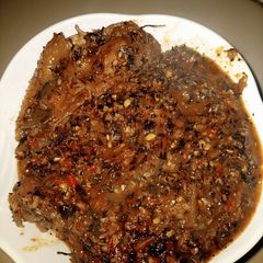 A picture of Bitter leaf soup with seseme seeds.