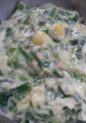 A picture of Palak paneer corn in cheese sauce.