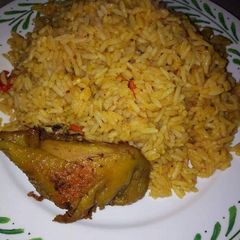 A picture of Jollof rice with fried chicken.