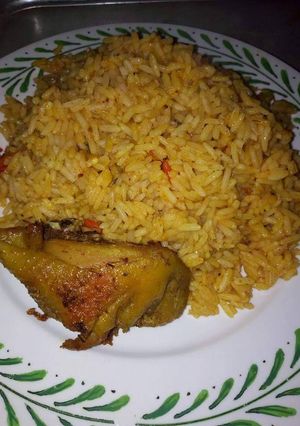 A picture of Jollof rice with fried chicken.