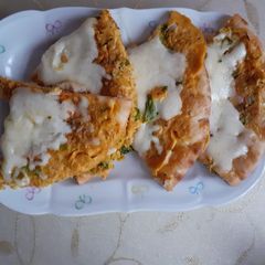 A picture of Omelet coated naan with cheese.