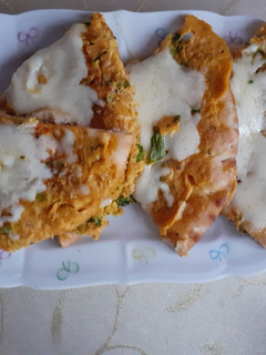 A picture of Omelet coated naan with cheese.