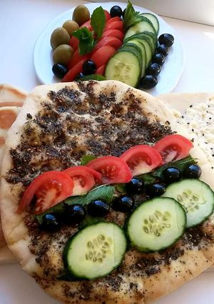 A picture of Lebanese_flat_bread_with_cheese_or_zaatar#Manoushe.