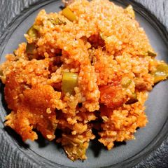 A picture of Spiced rice, sausage, and chicken.