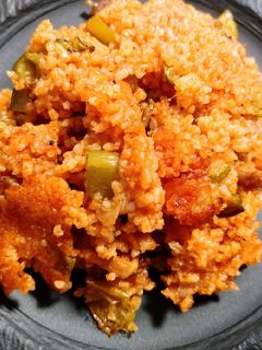 A picture of Spiced rice, sausage, and chicken.