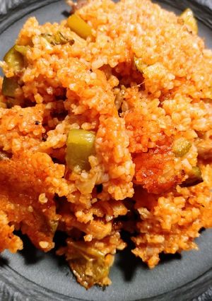 A picture of Spiced rice, sausage, and chicken.