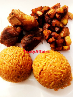 A picture of Jollof Rice/plantain served with Ram meat.