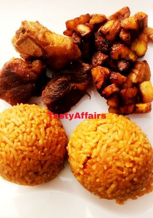A picture of Jollof Rice/plantain served with Ram meat.