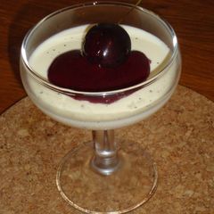 A picture of Vanilla Bean Panna Cotta with Cherry Sauce.