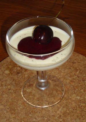 A picture of Vanilla Bean Panna Cotta with Cherry Sauce.