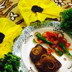 A picture of Fried Beef steak with veggies.