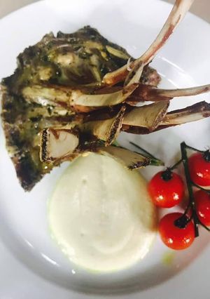 A picture of Lamb Rack on a bed of cauliflower puree.