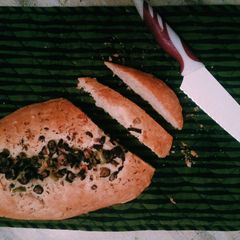 A picture of Italian bread with olives and fresh oregano🇮🇹🍞🌿.