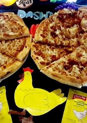 A picture of Chicken tikka pizza (karahi baking).