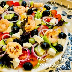 A picture of Greek salad with shrimps.