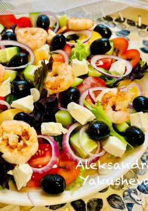 A picture of Greek salad with shrimps.
