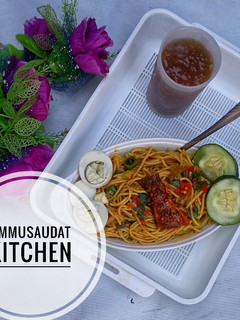 A picture of Pasta jollof with tamarind juice.