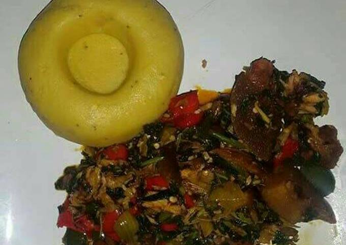 Pounded unripe plantain with assorted meat and vegetable soup