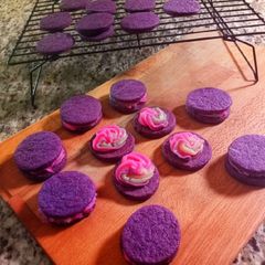A picture of Purple buttercream sugar cookie sandwiches.