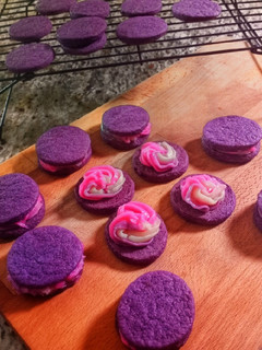 A picture of Purple buttercream sugar cookie sandwiches.