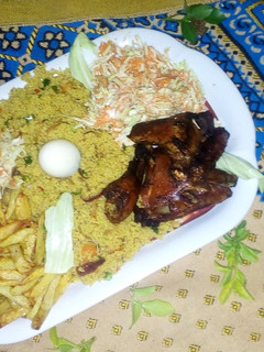 A picture of Fried cous cous,chicken with coleslaw and chips.