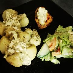 A picture of Baked potato and chicken breasts.