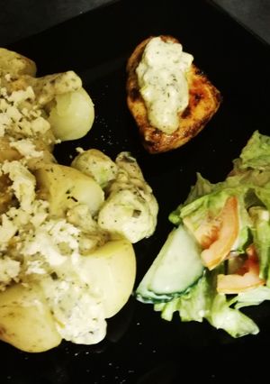 A picture of Baked potato and chicken breasts.