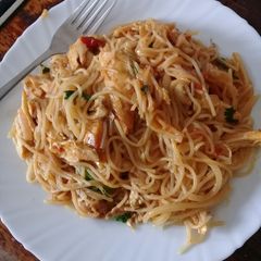 A picture of Leftover chicken with spaghetti.