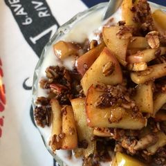 A picture of Yoghurt with apples and granola.