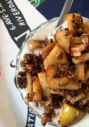 A picture of Yoghurt with apples and granola.