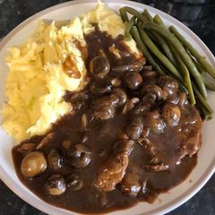 A picture of Slow cooked braising steak with mash and veg.