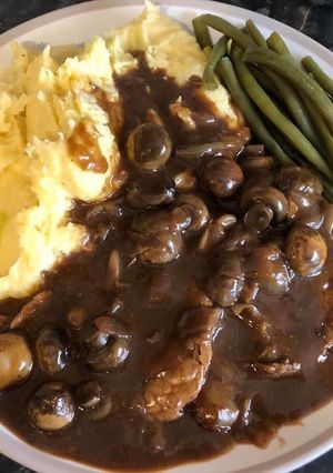 A picture of Slow cooked braising steak with mash and veg.