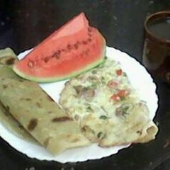 A picture of Kenyan Breakfast: Chapati, Omelette and Spiced Kenyan Black Tea.