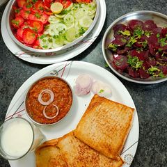 A picture of Bread bhaji, salad and buttermilk.