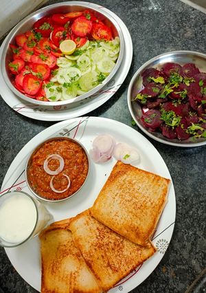 A picture of Bread bhaji, salad and buttermilk.