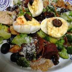 Buttery broccoli salad topped with deviled eggs A picture of Buttery broccoli salad topped with deviled eggs.