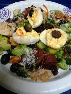 A picture of Buttery broccoli salad topped with deviled eggs.