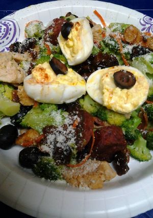 A picture of Buttery broccoli salad topped with deviled eggs.