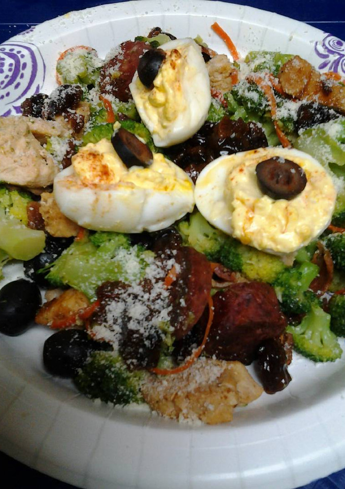 A picture of Buttery broccoli salad topped with deviled eggs.