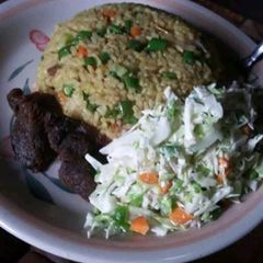Coconut rice and fried meat and salad A picture of Coconut rice and fried meat and salad.